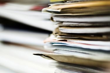 Stack of Folders and Paper Documents